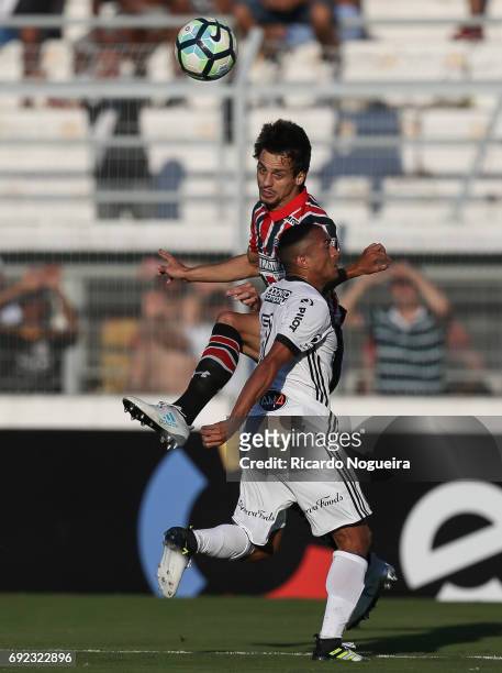 Rodrigo Caio of Sao Paulo battles for the ball with Nino Paraiba of Ponte Preta during the match between Ponte Preta and Sao Paulo as a part of...