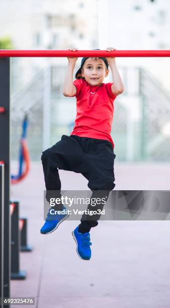 young boy make sport workout on the street - horizontal bar stock pictures, royalty-free photos & images