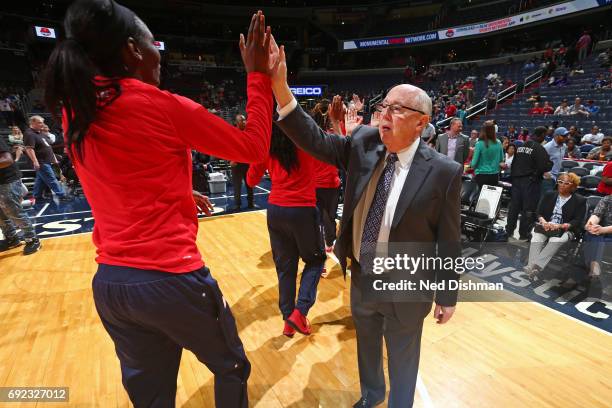 Mike Thibault of the Washington Mystics high fives a player before the game against the Chicago Sky on May 26, 2017 at the Verizon Center in...