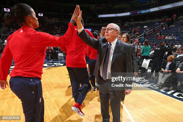 Mike Thibault of the Washington Mystics high fives a player before the game against the Chicago Sky on May 26, 2017 at the Verizon Center in...