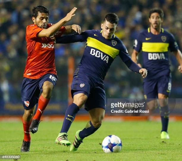Cristian Pavon of Boca Juniors fights for the ball with Walter Erviti of Independiente during a match between Boca Juniors and Independiente as part...