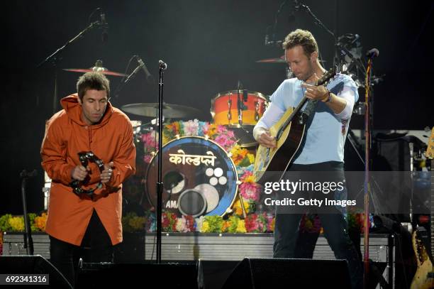 Free for editorial use. In this handout provided by 'One Love Manchester' benefit concert Liam Gallagher and Chris Martin perform on stage on June 4,...