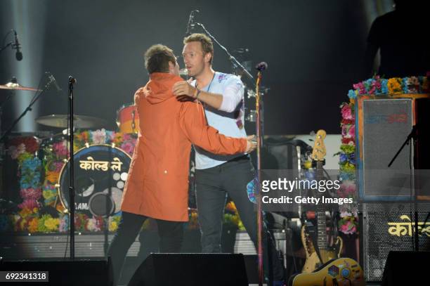 Free for editorial use. In this handout provided by 'One Love Manchester' benefit concert Liam Gallagher and Chris Martin perform on stage on June 4,...