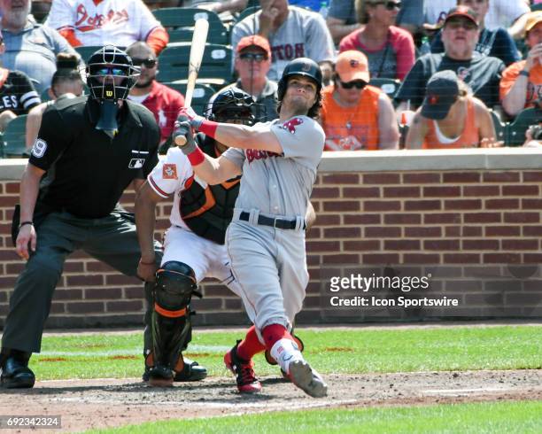 Boston Red Sox left fielder Andrew Benintendi follows the flight of his second home run of the game in the seventh inning against the Baltimore...