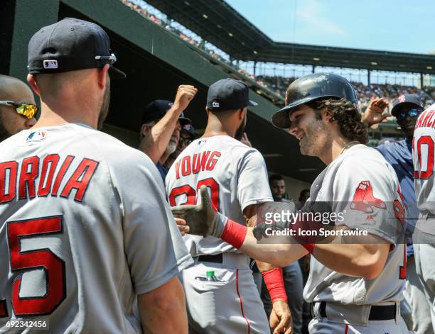 Boston Red Sox left fielder Andrew Benintendi is congratulated after hitting a solo home run in the third inning against the Baltimore Orioles on...