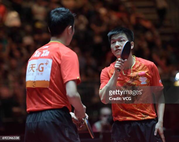 Xu Xin of China and Fan Zhendong of China compete during Men's Doubles final match against Masataka Morizono of Japan and Yuya Oshima of Japan on day...