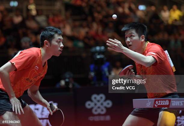 Xu Xin of China and Fan Zhendong of China compete during Men's Doubles final match against Masataka Morizono of Japan and Yuya Oshima of Japan on day...