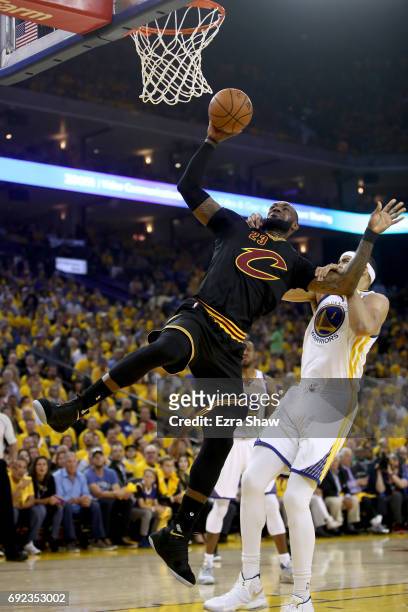LeBron James of the Cleveland Cavaliers is grabbed by JaVale McGee of the Golden State Warriors in Game 2 of the 2017 NBA Finals at ORACLE Arena on...