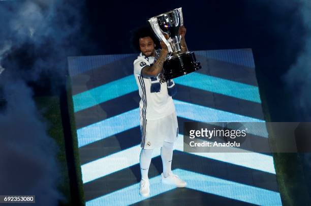 Marcelo Vieira of Real Madrid raises The UEFA Champions League trophy during celebrations at Santiago Bernabeu Stadium after winning the 2016/17 UEFA...