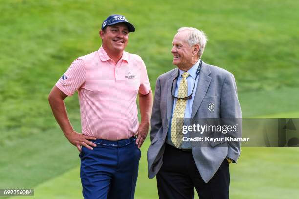 Jason Dufner smiles as he talks with tournament host Jack Nicklaus following his three stroke victory on the 18th hole green during the final round...