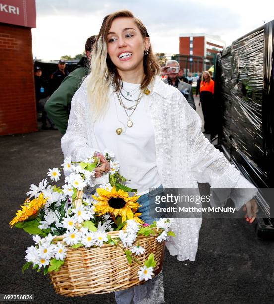 Miley Cyrus carries a basket of flowers during the One Love Manchester concert at Old Trafford Cricket Ground Cricket Club on June 4, 2017 in...