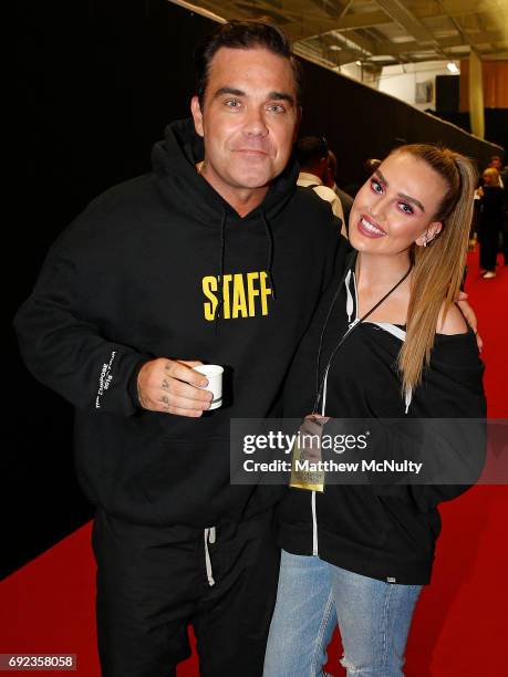 Robbie Williams and Perrie Edwards during the One Love Manchester concert at Old Trafford Cricket Ground Cricket Club on June 4, 2017 in Manchester,...