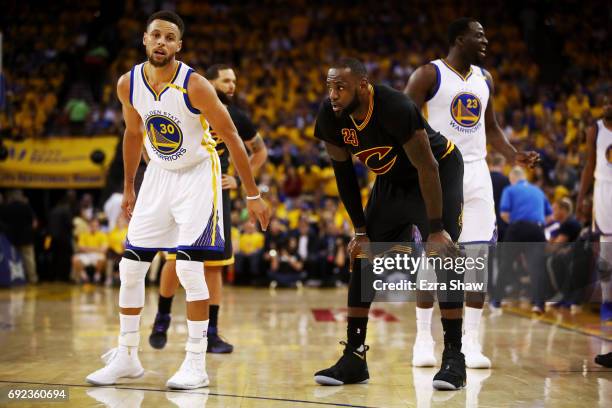 Stephen Curry and LeBron James of the Cleveland Cavaliers look on during the first half in Game 2 of the 2017 NBA Finals at ORACLE Arena on June 4,...