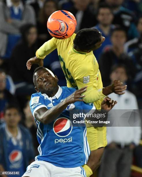 Duvier Riascos of Millonarios fights for the ball with Christian Mafla of Atletico Bucaramanga during the match between Millonarios and Atletico...