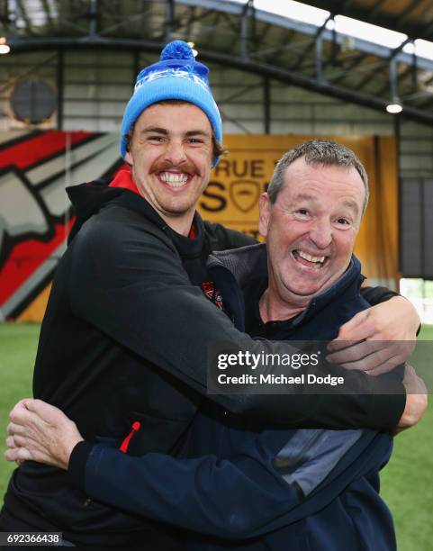 Bombers legend Neale Daniher gets a hug from nephew Joe Daniher of the Bombers after a cheque presentation to fight MND at the Essendon Football Club...