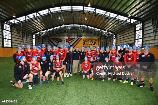 Bombers legend Neale Daniher poses with Bombers players during a cheque presentation to fight MND at the Essendon Football Club on June 5, 2017 in...