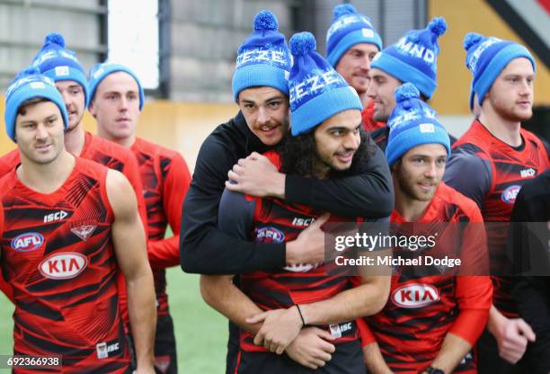 Joe Daniher of the Bombers hugs teammate Jake Long during a cheque presentation to fight MND at the Essendon Football Club on June 5, 2017 in...