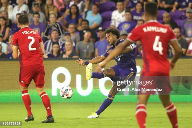 Giles Barnes of Orlando City SC kicks the ball between Matt Polster of Chicago Fire and Johan Kappelhof of Chicago Fire during a MLS soccer match...