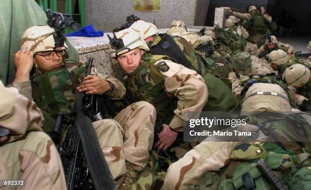 Members of the US Army 101st Airborne respond after enemy gunfire erupted as a plane carrying 20 Taliban and al Qaeda detainees took off from...