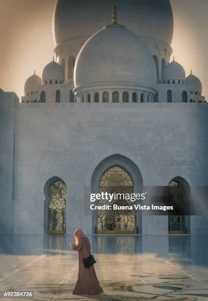 woman with abaya in a mosque - abu dhabi architecture stock pictures, royalty-free photos & images