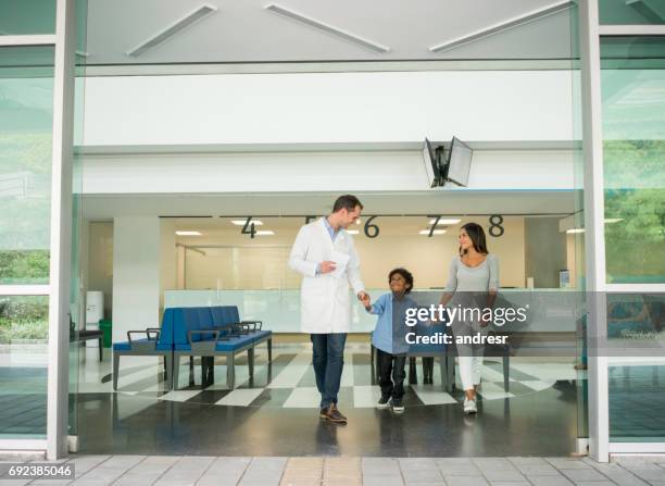 mother and son talking to a doctor at the hospital - doctor leaving stock pictures, royalty-free photos & images