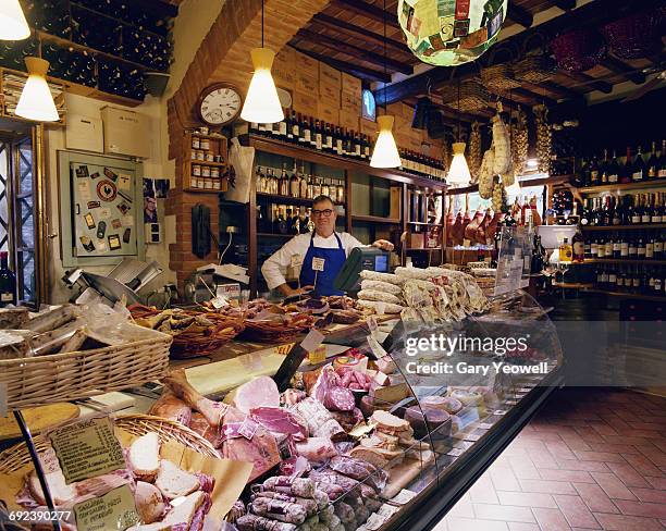 typical italian food shop with owner - siena italy stockfoto's en -beelden