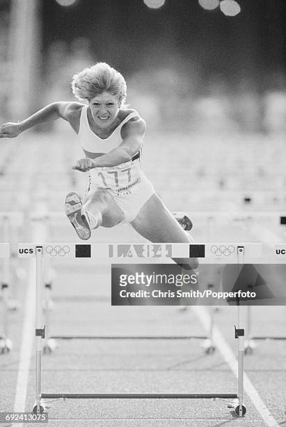 Shirley Strong of Great Britain competes to finish in second place to win the silver medal in the final of the Women's 100 metres hurdles event at...
