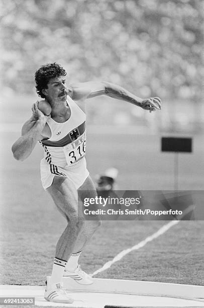 West German decathlete Jurgen Hingsen competes in the shot put event on the first day of the men's decathlon competition at the 1984 Summer Olympics...