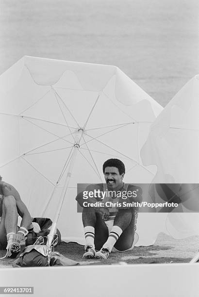 Daley Thompson of Great Britain pictured taking a rest between competition in disciplines on the first day of the decathlon competition at the 1984...