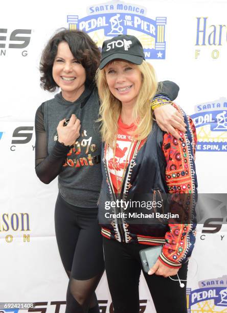 Joyce Hyser Robinson and Rosanna Arquette attend Pedal On The Pier at Santa Monica Pier on June 4, 2017 in Santa Monica, California.