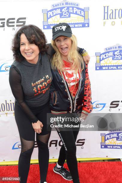 Joyce Hyser Robinson and Rosanna Arquette attend Pedal On The Pier at Santa Monica Pier on June 4, 2017 in Santa Monica, California.