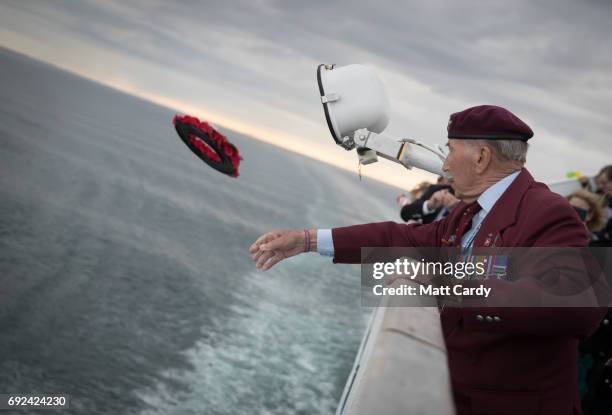 Tom Schaffer who was a paratrooper during the battle of the Ardennes throws a wreath into the sea as military veterans and passengers gather for a...