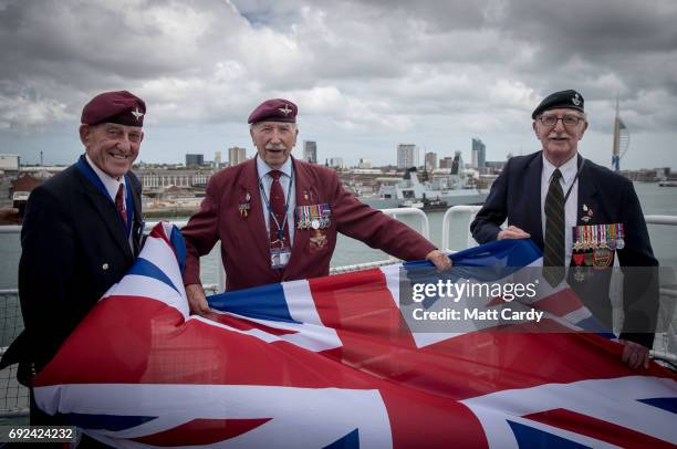 Ex-paratroper John Pinkerton Tom Schaffer who was a paratrooper during the battle of the Ardennes and James Corrigan pose for a photograph on the...