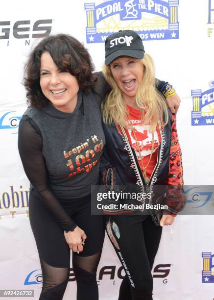 Joyce Hyser Robinson and Rosanna Arquette attend Pedal On The Pier at Santa Monica Pier on June 4, 2017 in Santa Monica, California.