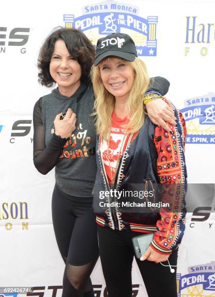 Joyce Hyser Robinson and Rosanna Arquette attend Pedal On The Pier at Santa Monica Pier on June 4, 2017 in Santa Monica, California.