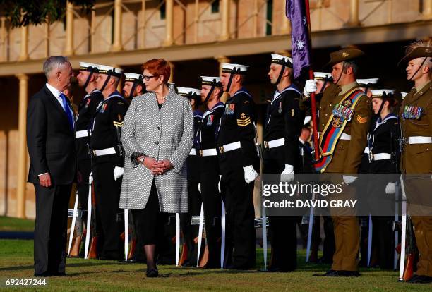 Secretary of Defence Jim Mattis walks with Australia's Defence Minister Marise Payne during an inspection of a guard of honour as part of the 2017...