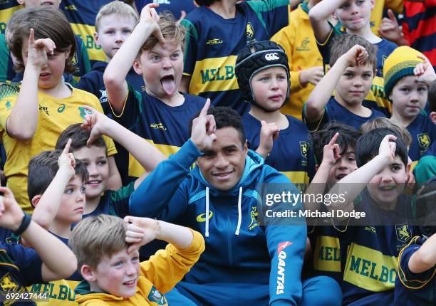 Will Genia of the Wallabies gesture while posing with fans during an Australian Wallabies training session at the Melbourne Rugby Union Football Club...