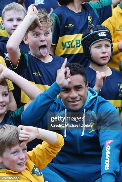 Will Genia of the Wallabies gesture while posing with fans during an Australian Wallabies training session at the Melbourne Rugby Union Football Club...