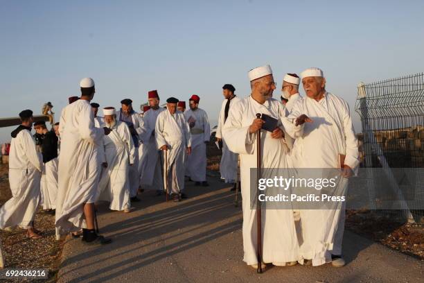 Samaritans participate in a traditional ceremony celebrating the giving of the Torah on "Shavuot festival", at Mount Gerizim near the West Bank city...