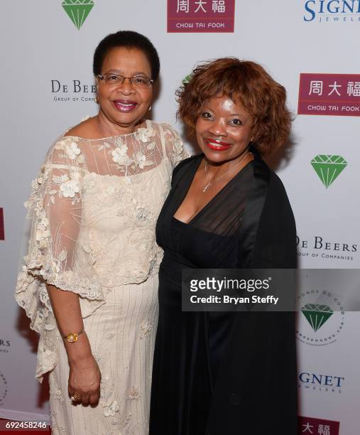 Humanitarian Graca Machel and a guest arrive at the Diamond Empowerment Fund's Diamonds Do Good awards gala at the Four Seasons Hotel Las Vegas on...