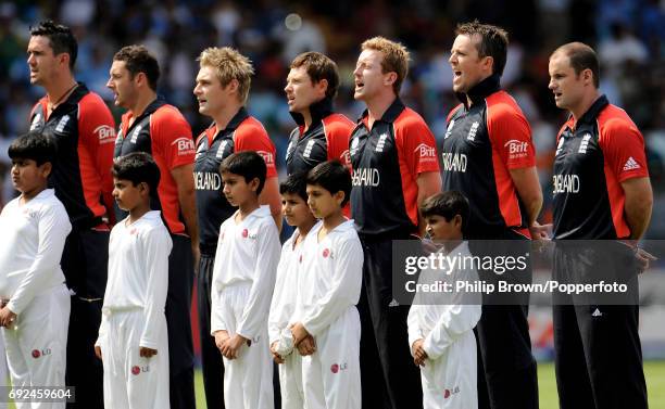 Some of the England cricket team with Indian schoolboys during the National Anthems prior to the ICC Cricket World Cup group B match between India...