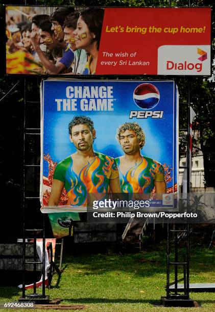 Advertisements, featuring local heroes Tillakaratne Dilshan and Lasith Malinga, at the Colombo Cricket Club where spectators watch matches on a big...