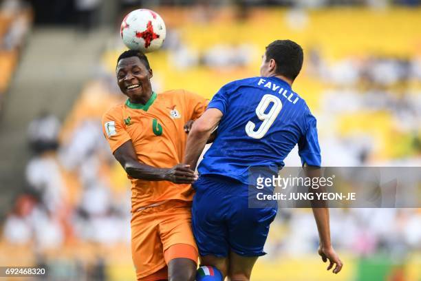 Zambia's defender Muchindu Muchindu and Italy's forward Andrea Favilli compete for the ball during the U-20 World Cup quarter-final football match...
