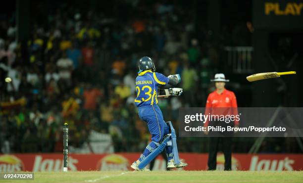 The bat flies out of the hands of Sri Lanka's Tillakaratne Dilshan during their victory over England in their ICC Cricket World Cup 2011...