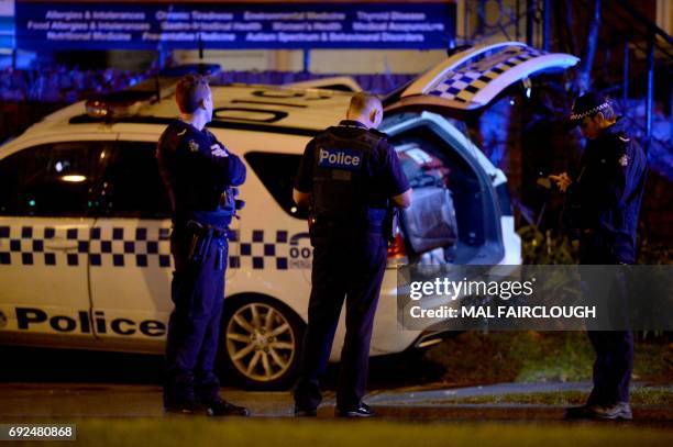 Police are pictured in the Melbourne bayside suburb of Brighton on June 5 after a woman was held against her will in an apartment block in an...