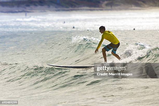 teenage boy surfing. - baja california sur stock-fotos und bilder