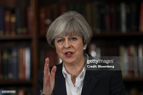 Theresa May, U.K. Prime minister and leader of the Conservative Party, gestures while delivering a speech at the Royal United Services Institute in...