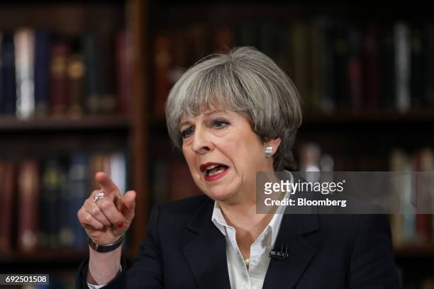 Theresa May, U.K. Prime minister and leader of the Conservative Party, gestures while delivering a speech at the Royal United Services Institute in...