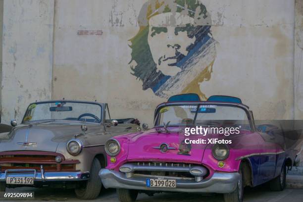 che guevara icon on wall and on vintage car in havana - che guevara stock pictures, royalty-free photos & images