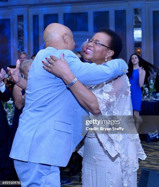 Diamond Empowerment Fund Co-Founder and music producer Russell Simmons congratulates humanitarian Graca Machel after she received the "Diamonds Do...